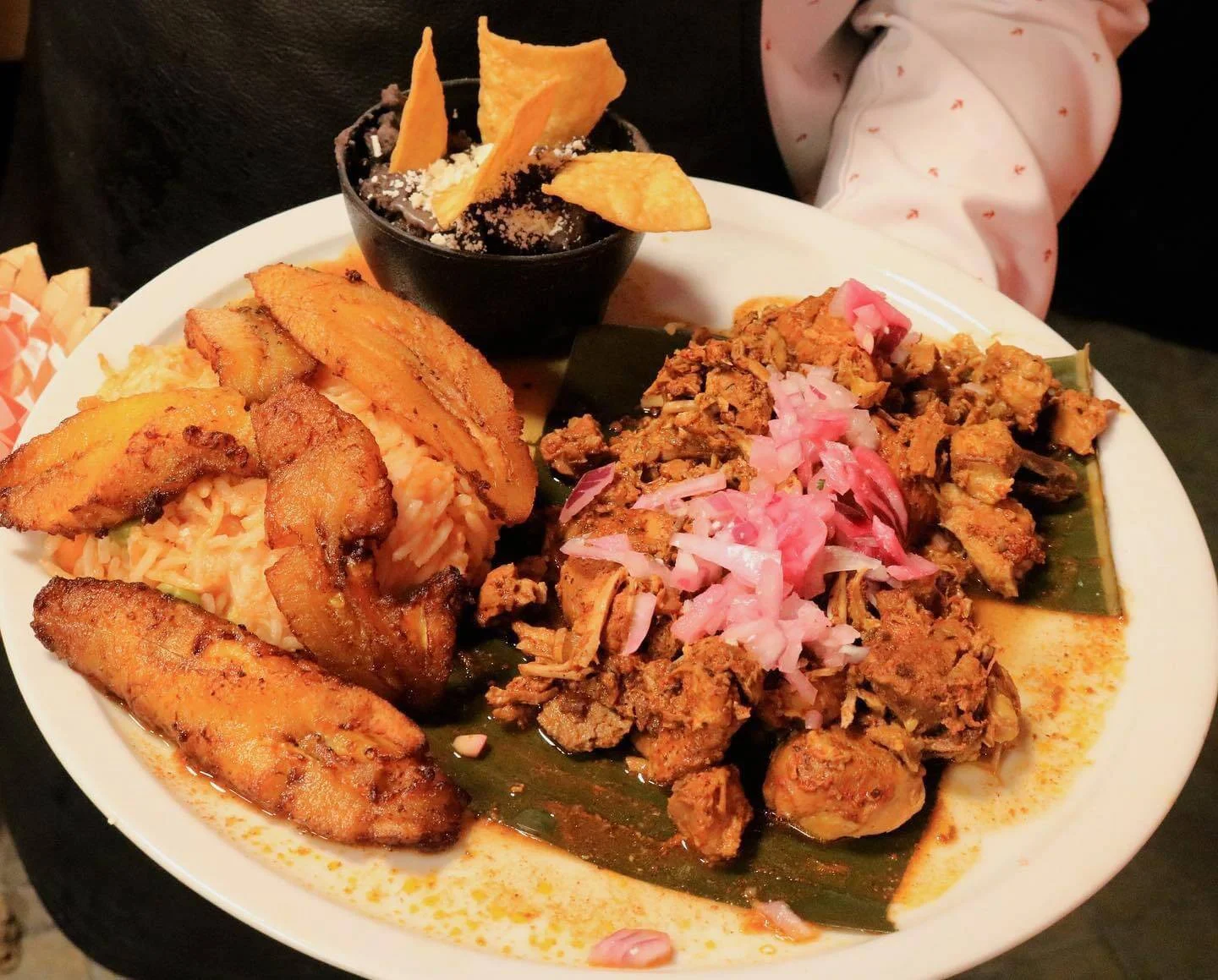 Cochinita pibil with pickled red onion, plantains, and beans at Hacienda Santa Teresa
