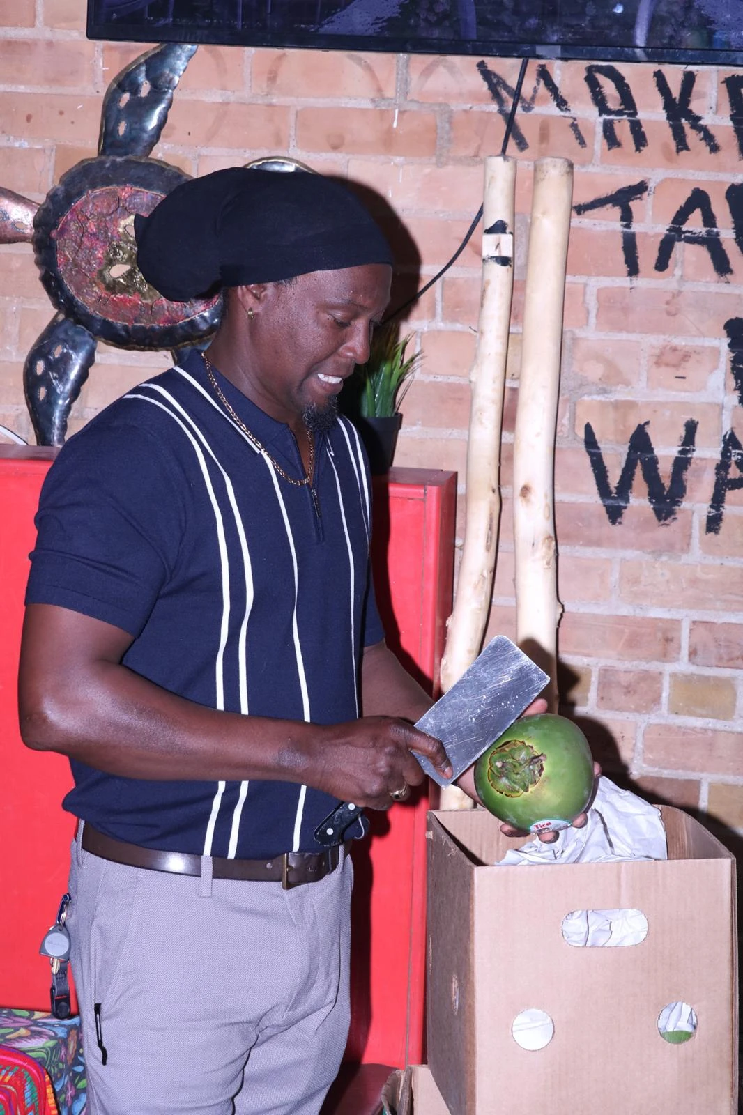 A team member preparing a fresh coconut inside Hacienda Santa Teresa