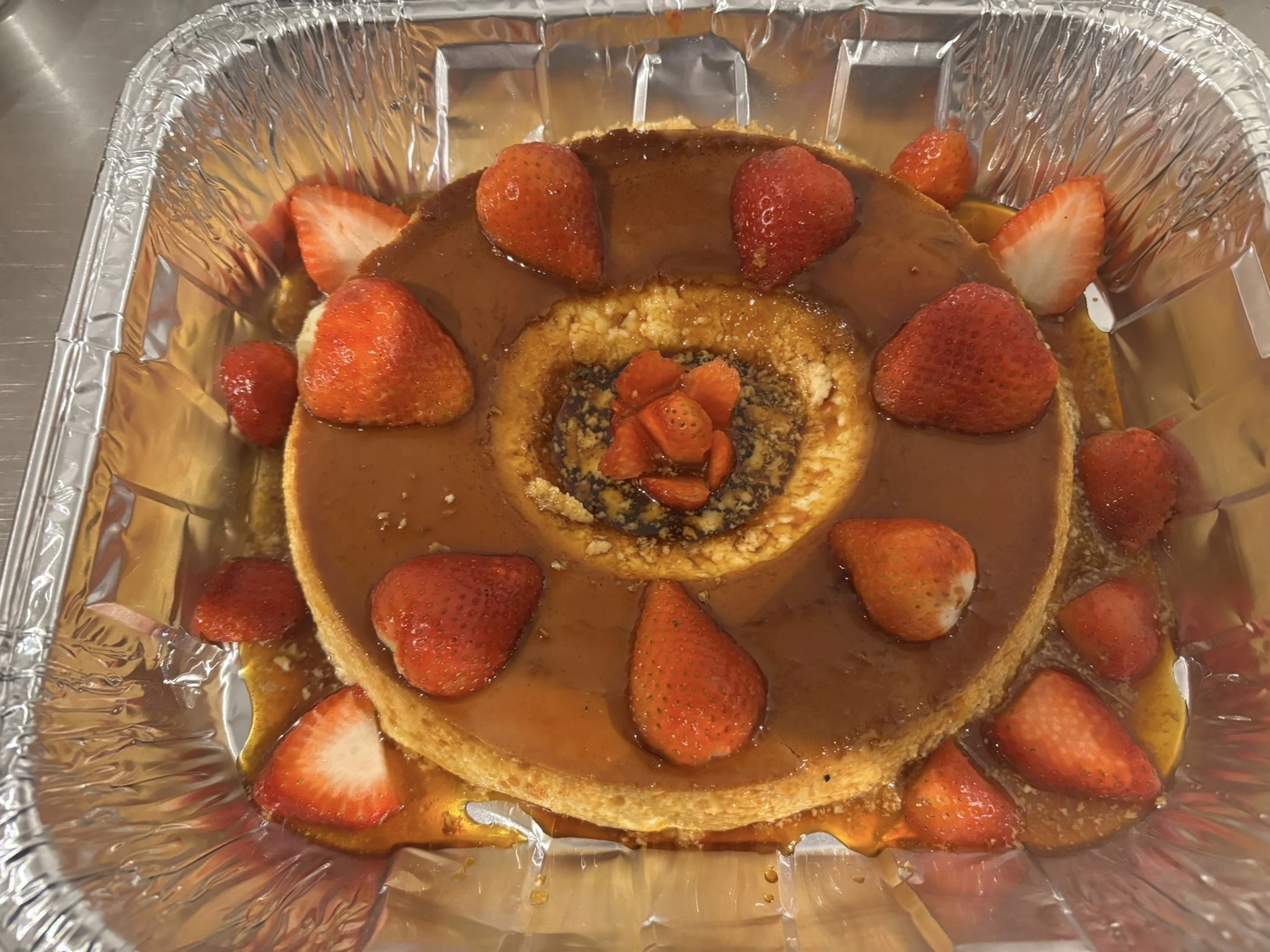A caramel-topped ring-shaped flan decorated with strawberries at Hacienda Santa Teresa