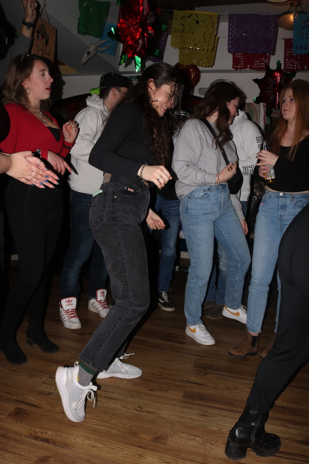 Friends dancing together under colourful decorations at Hacienda Santa Teresa