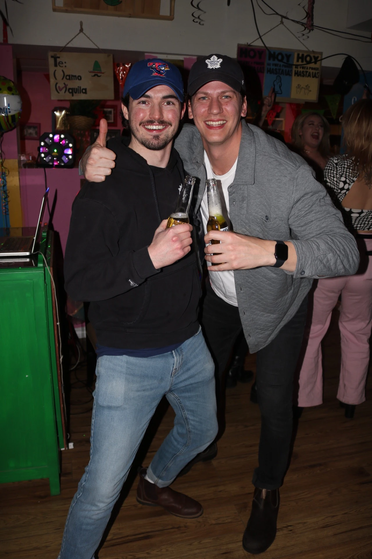 Two friends smiling together during a night out at Hacienda Santa Teresa