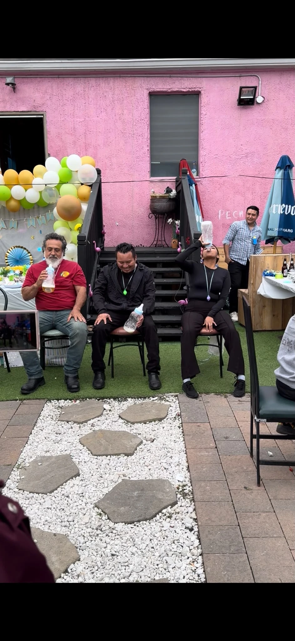 Guests playing a baby-shower game on Hacienda Santa Teresa’s patio