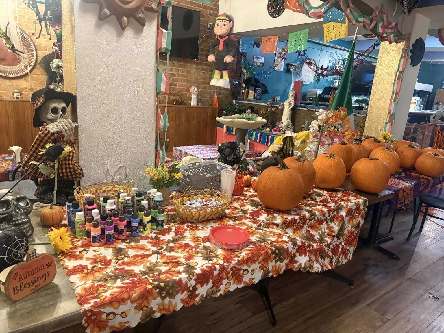 Pumpkins and colourful paints set out for a pumpkin-decorating night at Hacienda Santa Teresa
